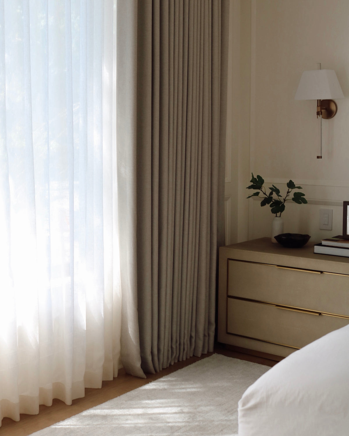 Modern sun-filled bedroom with white custom semi sheer curtains in Vale Collection by Thoa Home.