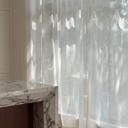 Custom semi-sheer Chantilly cream curtains in Vale Collection by Thoa Home with a marble countertop in modern kitchen.