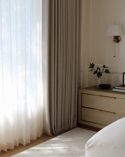Modern sun-filled bedroom with white custom semi sheer curtains in Vale Collection by Thoa Home.